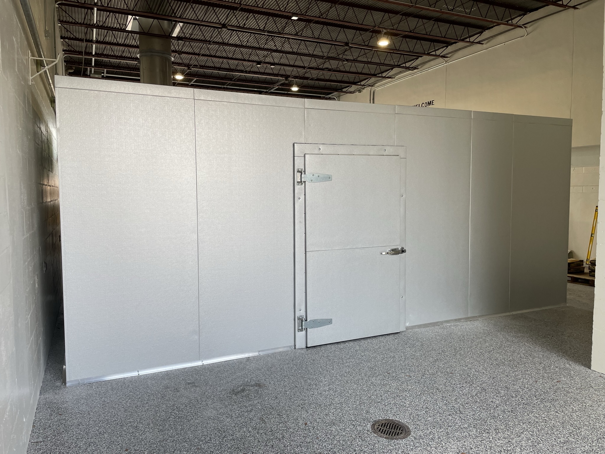Installed indoor walk-in cooler with door and commercial hardware